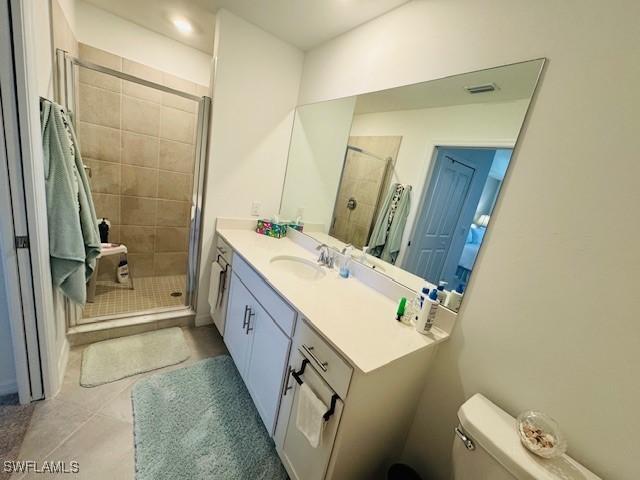 5629 Double Eagle Cir Unit 4224, Ave Maria, FL 34142 - bathroom featuring toilet, a shower stall, tile patterned flooring, and vanity