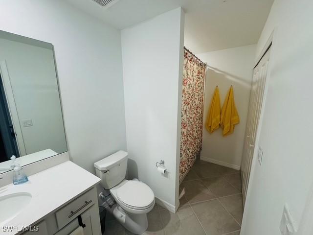5629 Double Eagle Cir Unit 4224, Ave Maria, FL 34142 - bathroom featuring vanity, tile patterned flooring, toilet, baseboards, and a shower with curtain