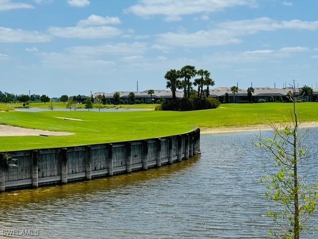 5629 Double Eagle Cir Unit 4224, Ave Maria, FL 34142 - dock area featuring a lawn, a water view, and golf course view