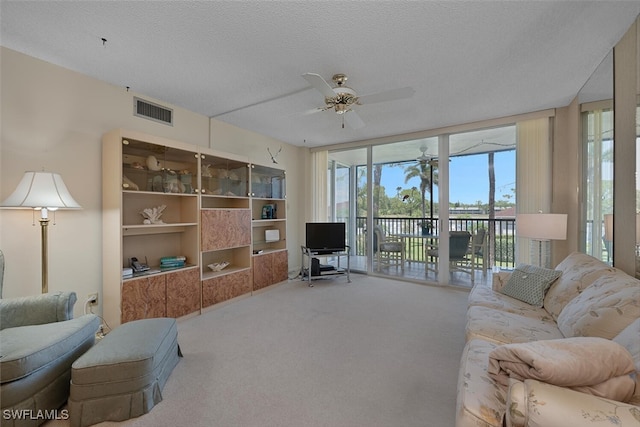 25804 Cockleshell Dr Unit 216, Bonita Springs, FL 34135 - carpeted living area featuring ceiling fan and a textured ceiling