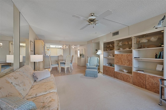 25804 Cockleshell Dr Unit 216, Bonita Springs, FL 34135 - living room with a chandelier, a ceiling fan, a textured ceiling, light colored carpet, and baseboards