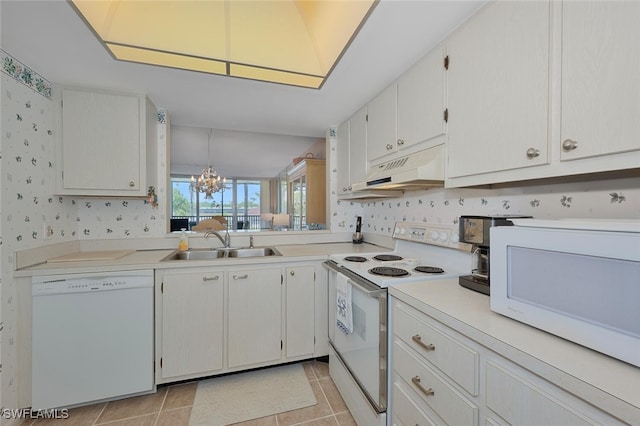 25804 Cockleshell Dr Unit 216, Bonita Springs, FL 34135 - kitchen with white appliances, under cabinet range hood, a sink, wallpapered walls, and a chandelier