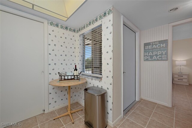 25804 Cockleshell Dr Unit 216, Bonita Springs, FL 34135 - bathroom with wallpapered walls, tile patterned flooring, and baseboards