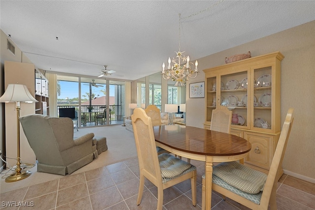 25804 Cockleshell Dr Unit 216, Bonita Springs, FL 34135 - dining area featuring a chandelier, expansive windows, light tile patterned flooring, a ceiling fan, and a textured ceiling