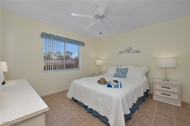 25804 Cockleshell Dr Unit 216, Bonita Springs, FL 34135 - bedroom featuring light tile patterned floors, baseboards, a ceiling fan, and a textured ceiling
