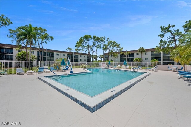 25804 Cockleshell Dr Unit 216, Bonita Springs, FL 34135 - community pool with a patio and fence