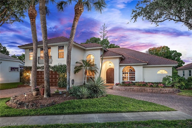 7996 Beaumont Ct, Naples, FL 34109 - mediterranean / spanish home featuring stucco siding, a tiled roof, a front lawn, and decorative driveway