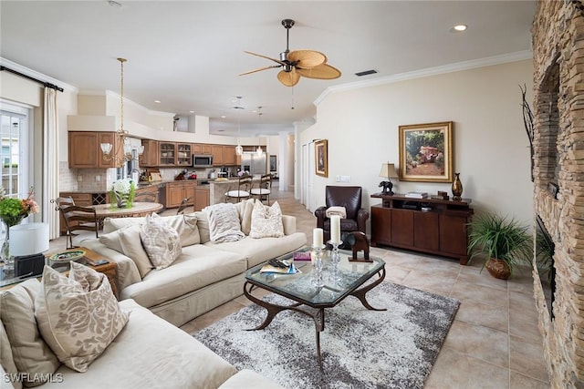 7996 Beaumont Ct, Naples, FL 34109 - living room featuring ceiling fan, ornamental molding, light tile patterned flooring, and recessed lighting