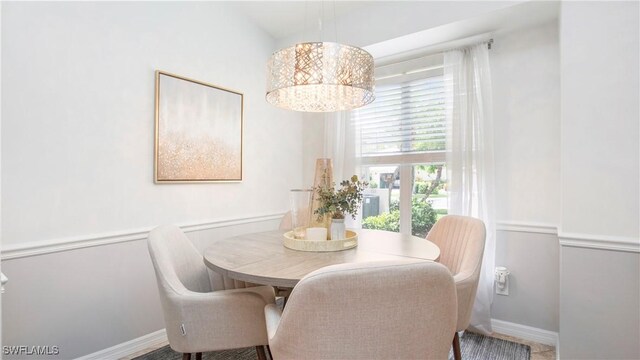 6949 Lone Oak Blvd, Naples, FL 34109 - dining space with a chandelier and baseboards