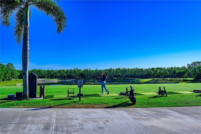 view of community with a lawn and a water view