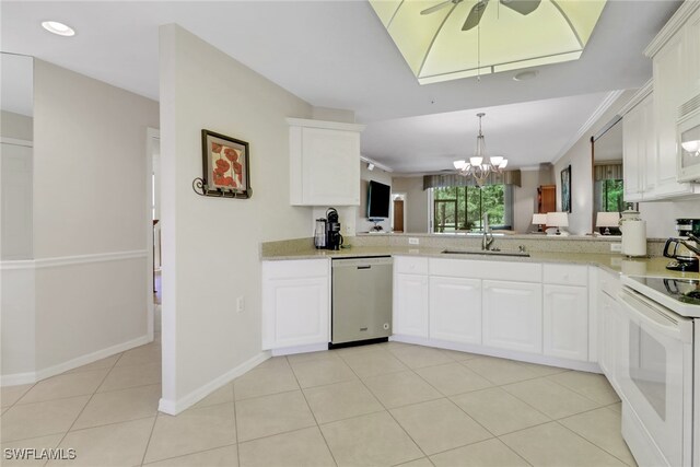 kitchen with a sink, light tile patterned floors, ceiling fan with notable chandelier, white appliances, and white cabinetry