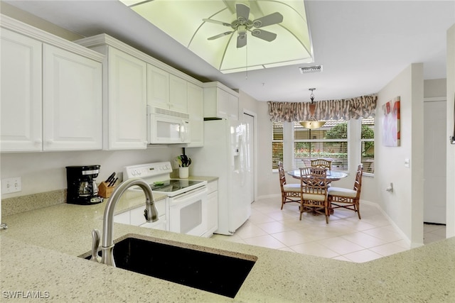 kitchen featuring white appliances, light stone countertops, white cabinets, a ceiling fan, and light tile patterned floors