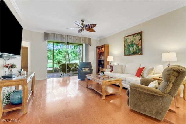 living room featuring baseboards, ceiling fan, ornamental molding, and light wood finished floors