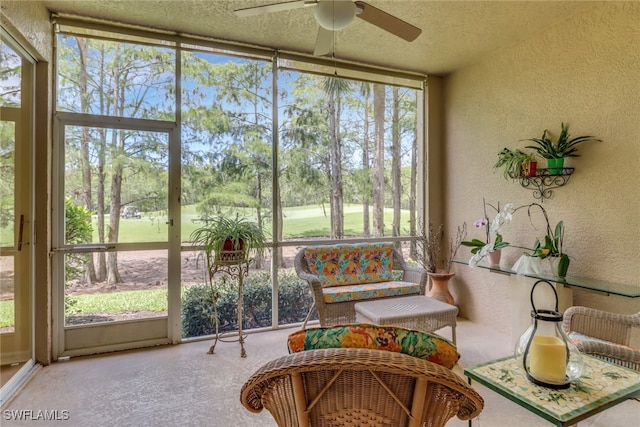 sunroom / solarium featuring ceiling fan