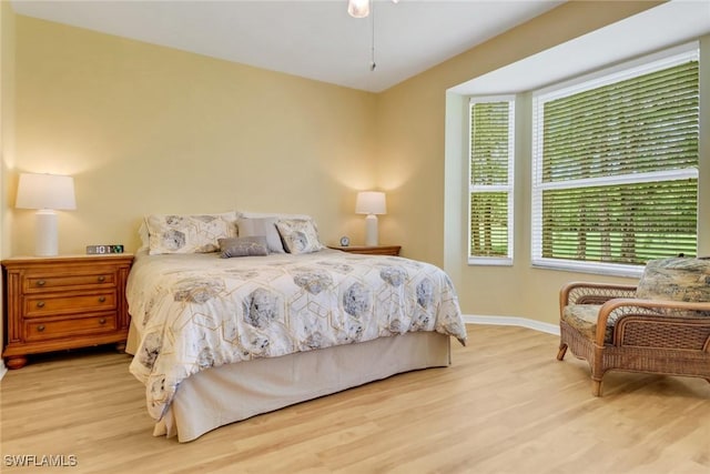 bedroom with baseboards and wood finished floors