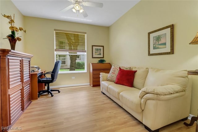 home office featuring a ceiling fan, baseboards, and light wood-style floors