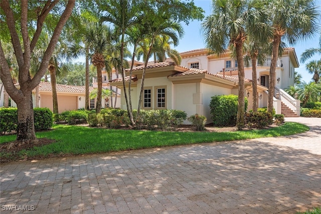 mediterranean / spanish-style home featuring stucco siding and a tiled roof