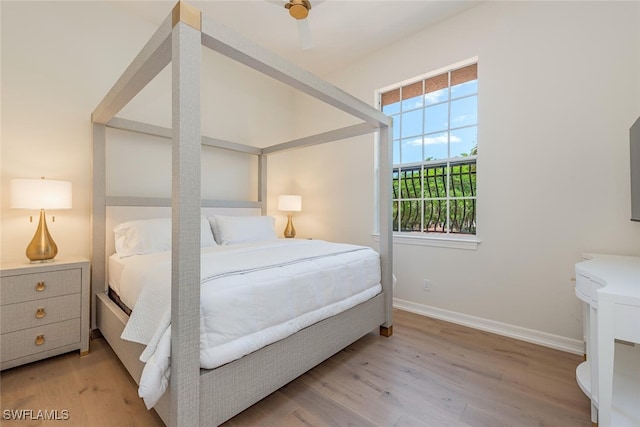 bedroom with baseboards and light wood-style flooring