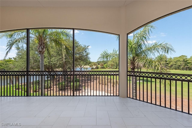 unfurnished sunroom with a water view