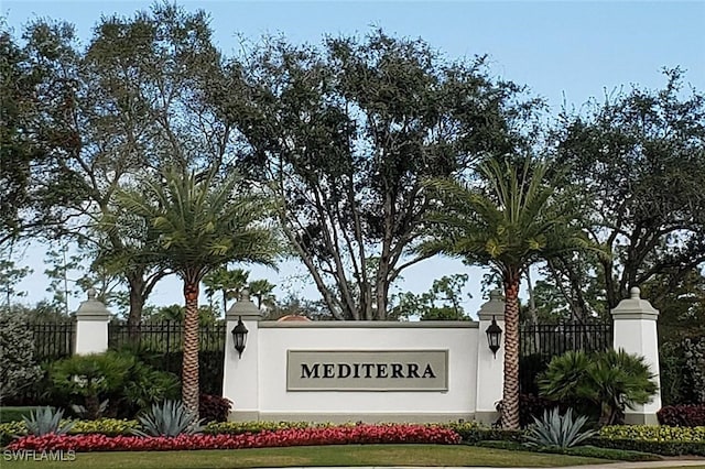 community sign featuring fence