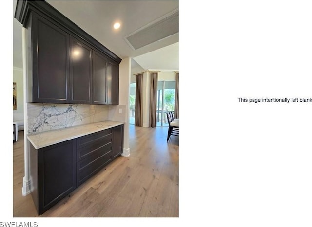16995 Porta Vecchio Way Unit 202, Naples, FL 34110 - kitchen with light wood-type flooring, backsplash, light countertops, recessed lighting, and baseboards