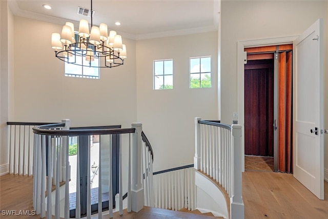 16995 Porta Vecchio Way Unit 202, Naples, FL 34110 - stairway featuring wood finished floors, a chandelier, crown molding, recessed lighting, and baseboards