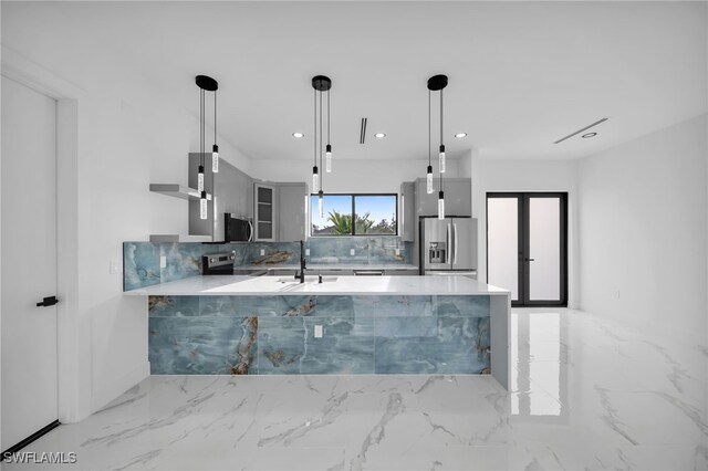 4026 SE 3rd Ave, Cape Coral, FL 33904 - kitchen with a peninsula, marble finish floor, appliances with stainless steel finishes, and tasteful backsplash