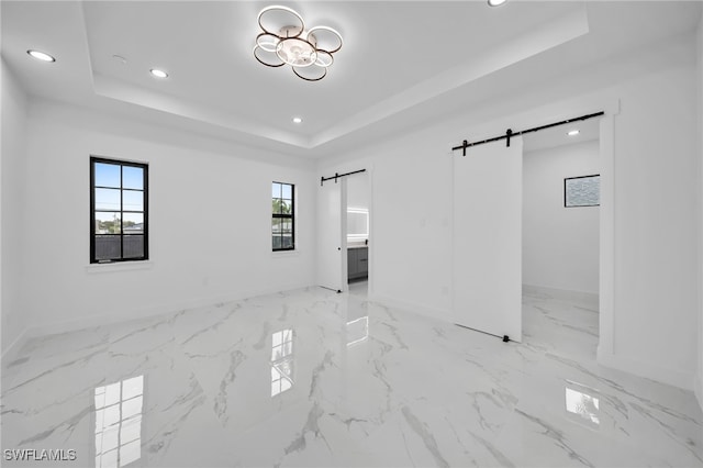 4026 SE 3rd Ave, Cape Coral, FL 33904 - unfurnished bedroom with recessed lighting, a barn door, a raised ceiling, and baseboards