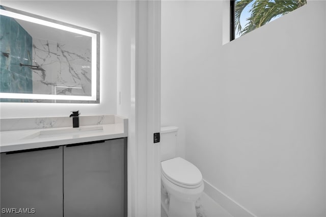 4026 SE 3rd Ave, Cape Coral, FL 33904 - full bathroom with vanity, baseboards, toilet, marble finish floor, and a marble finish shower