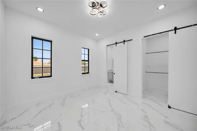 4026 SE 3rd Ave, Cape Coral, FL 33904 - unfurnished bedroom featuring recessed lighting, a barn door, marble finish floor, and multiple windows