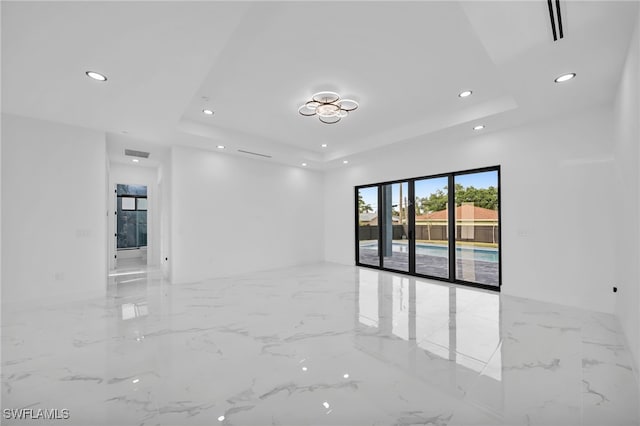 4026 SE 3rd Ave, Cape Coral, FL 33904 - empty room featuring recessed lighting, marble finish floor, a tray ceiling, and visible vents