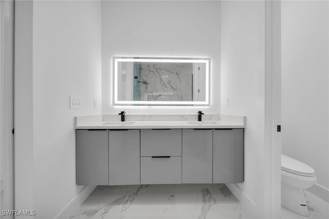 4026 SE 3rd Ave, Cape Coral, FL 33904 - bathroom with toilet, baseboards, a sink, and marble finish floor
