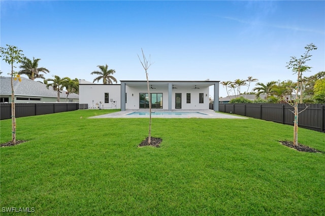 4026 SE 3rd Ave, Cape Coral, FL 33904 - back of house featuring a yard, a ceiling fan, and a fenced backyard