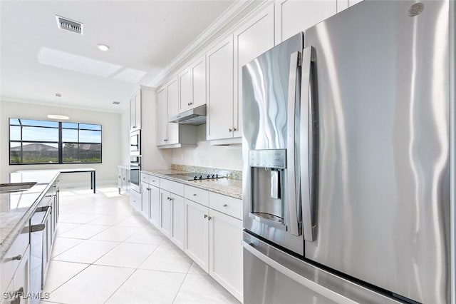 kitchen featuring stainless steel appliances, white cabinetry, light tile patterned floors, under cabinet range hood, and visible vents