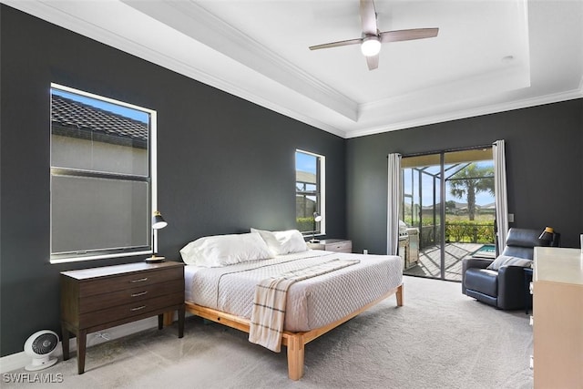 carpeted bedroom with crown molding, a raised ceiling, access to outside, and ceiling fan