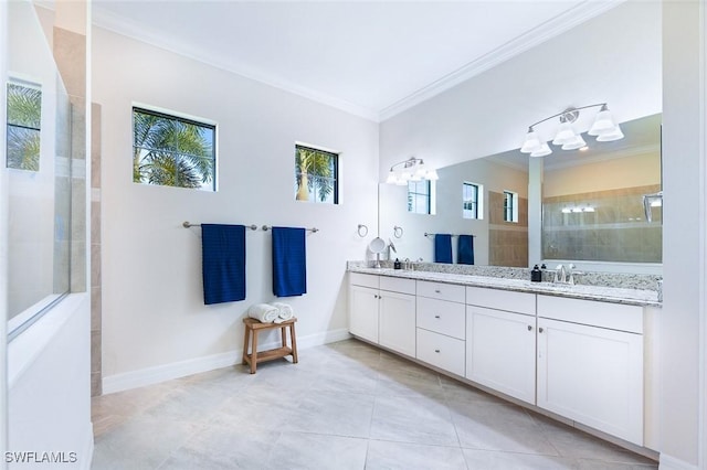 bathroom with a sink, ornamental molding, tiled shower, and tile patterned flooring