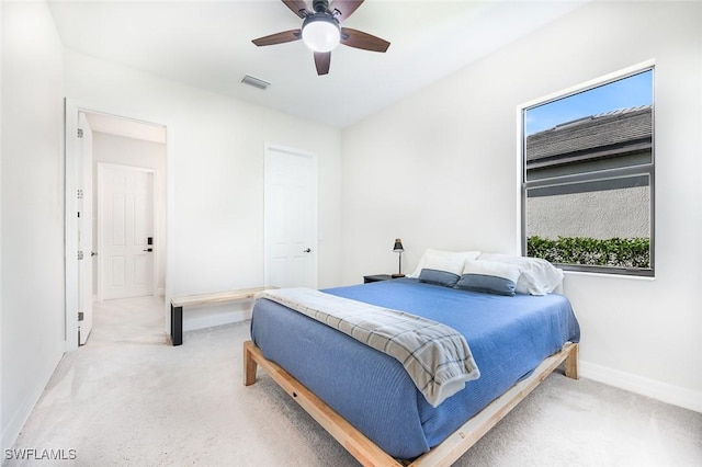 bedroom featuring visible vents, baseboards, ceiling fan, and light colored carpet