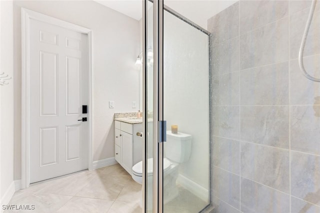 full bathroom with vanity, toilet, baseboards, and a stall shower