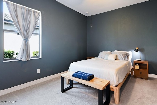bedroom with baseboards and carpet flooring