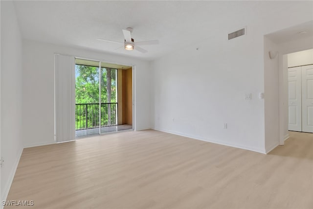 spare room featuring light wood-style flooring, ceiling fan, and baseboards