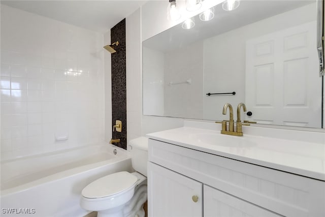 bathroom featuring toilet, vanity, and bathtub / shower combination
