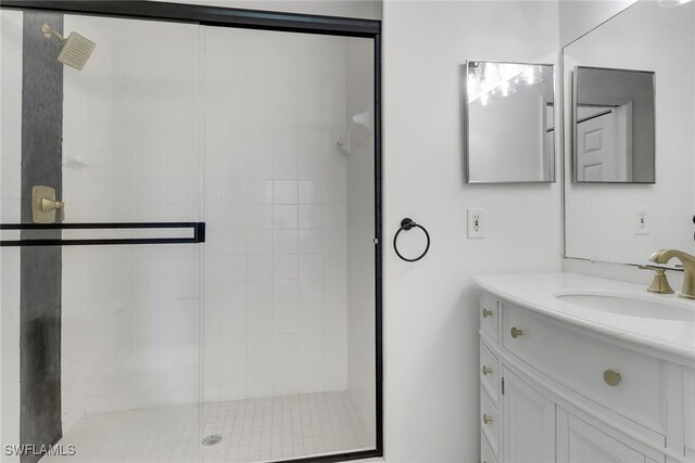 full bath with a shower stall and vanity