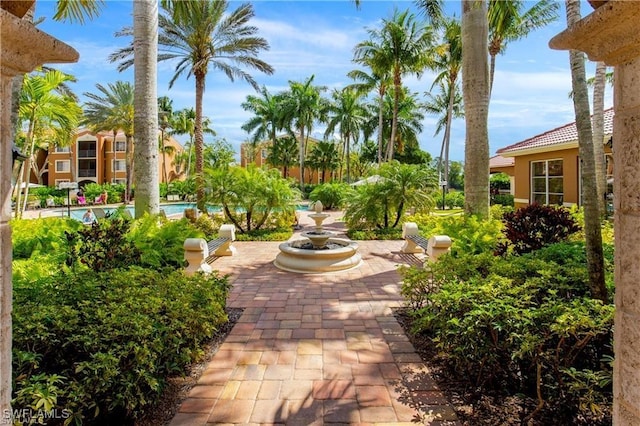 surrounding community with a patio and a pool