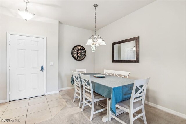 dining room featuring light tile patterned floors, baseboards, and a chandelier