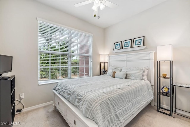 bedroom featuring baseboards, light carpet, and ceiling fan