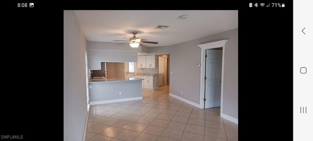 321 Dania St, Lehigh Acres, FL 33936 - kitchen featuring ceiling fan, white cabinetry, light tile patterned floors, light countertops, and backsplash