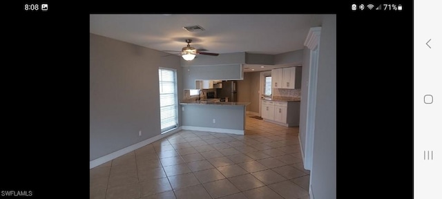 321 Dania St, Lehigh Acres, FL 33936 - kitchen with white cabinetry, ceiling fan, a peninsula, backsplash, and baseboards
