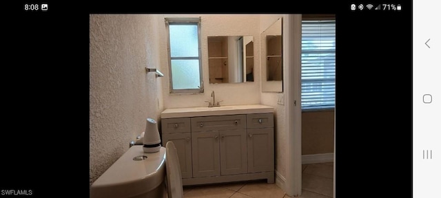 321 Dania St, Lehigh Acres, FL 33936 - bathroom featuring tile patterned flooring, vanity, and a textured wall