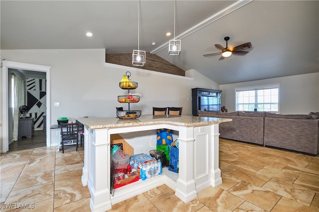 kitchen featuring lofted ceiling, a ceiling fan, light stone countertops, open floor plan, and a kitchen island