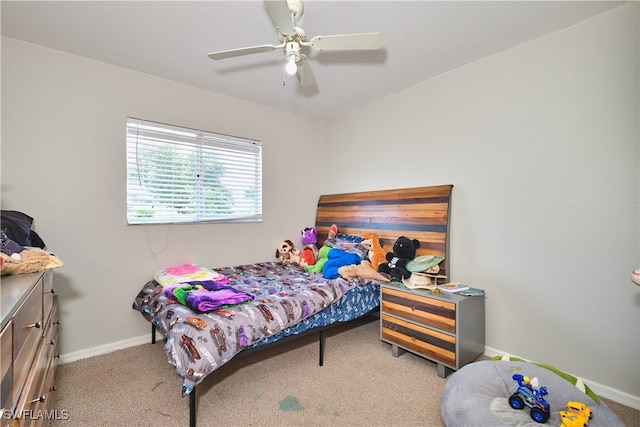 carpeted bedroom with baseboards and ceiling fan